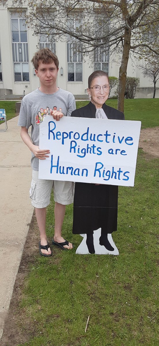 CathyGoike's tweet photo. Had a reproductive rights rally in rural NE Michigan today.  So many people came with signs and megaphones. my son's first rally and he's hooked. Way more supportive honks and thumbs up than expected. https://t.co/kZJrhzitU8