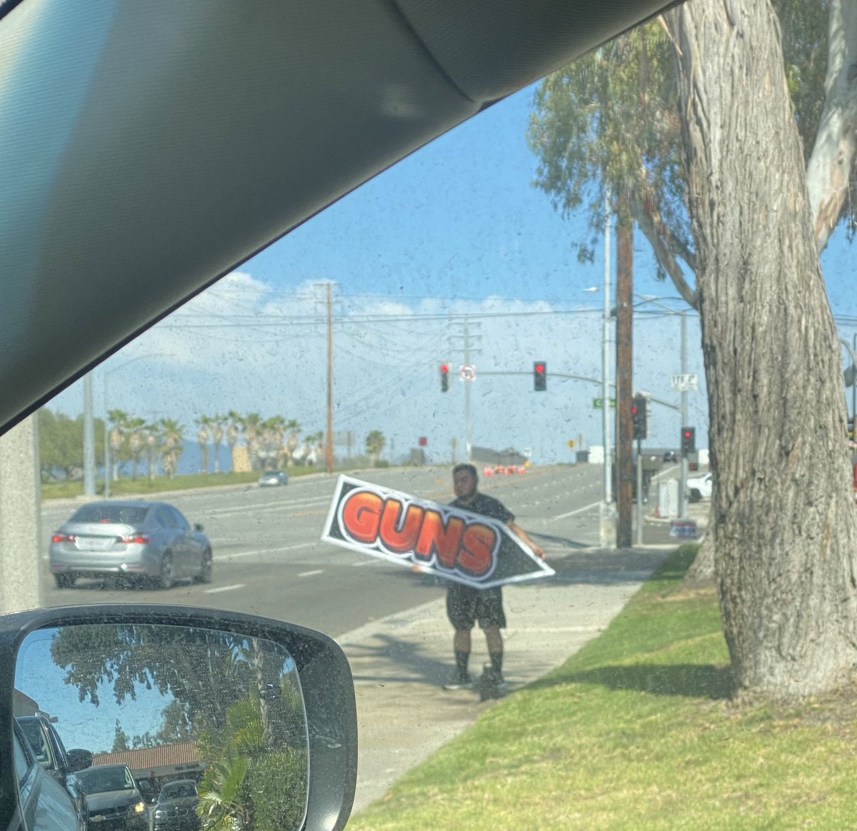 BrendanWiles's tweet photo. Less than 2 miles from the Laguna Woods Geneva Presbyterian shooting and there’s a GUNS sign spinner out, same day. This is the display in their store front.

Makes me sick. https://t.co/jSfDsd1fRJ