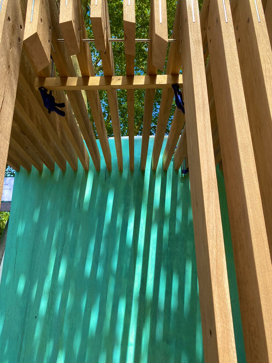 New Forest Green Oak (originally used in lifeboat construction), deployed here in the @RNLI Chelsea garden as a sheltered arcade, creates rippled shadows on copper. #RNLIatChelsea #ProjectGivingBack #RHSChelsea