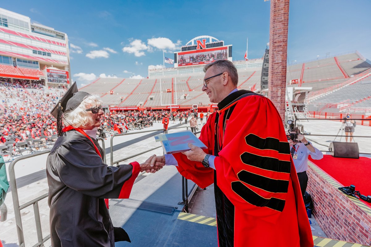 UNLincoln's tweet photo. “I did the work..I just didn't get to stay and finish my hours.” On May 14, Carol Livingston crossed the stage &amp; received her @NebraskaBiz degree—a moment 63 years in the making—with her family cheering her on from the stands. Read her story: https://t.co/IngK6vx6mD #GoBigGrad https://t.co/Mbyb1HwR03