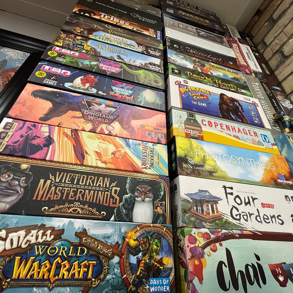 boardgamecoffee's tweet photo. When you run out of shelf space you gotta rely on those mad stacking skills #MadStacks This stack actually goes all the way to the floor but this is the best I could get due to the fact that the stack is surrounded by unopened Kickstarter fulfilments lol. https://t.co/v5NJQSKPwL