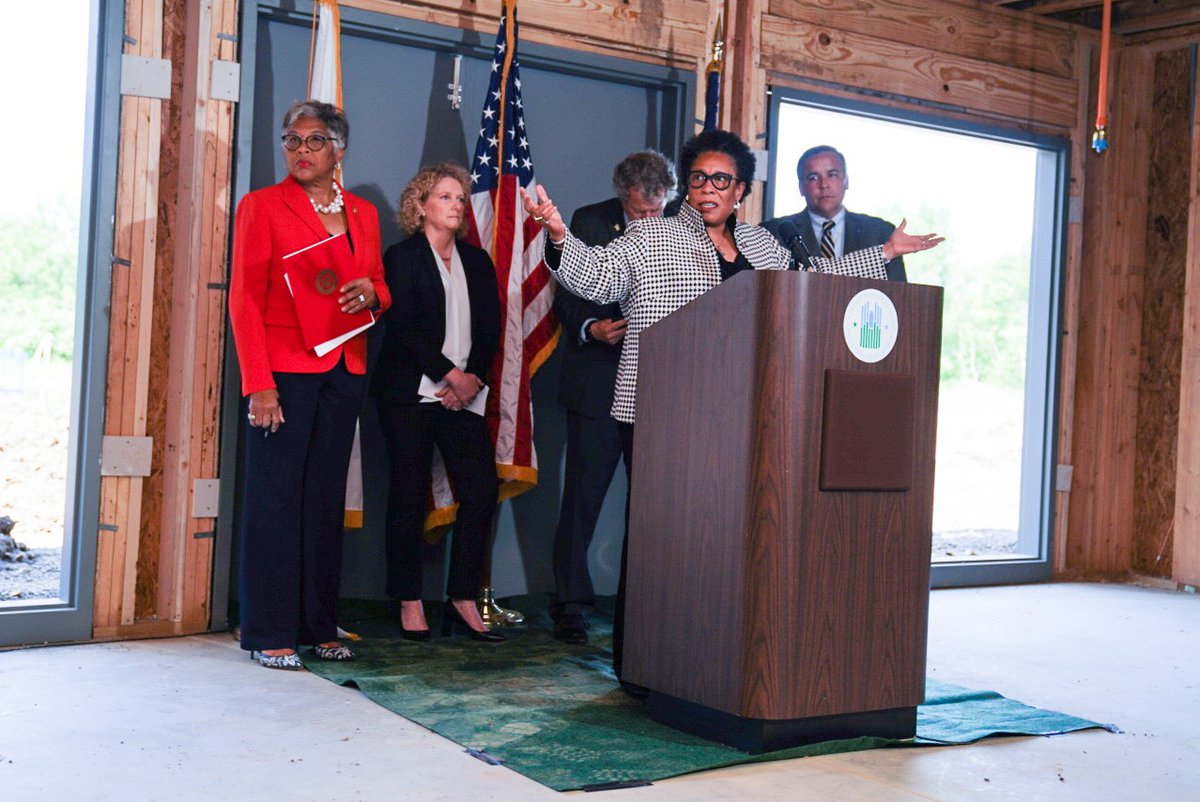 Secretary Fudge joins lawmakers and a housing leader at the podium