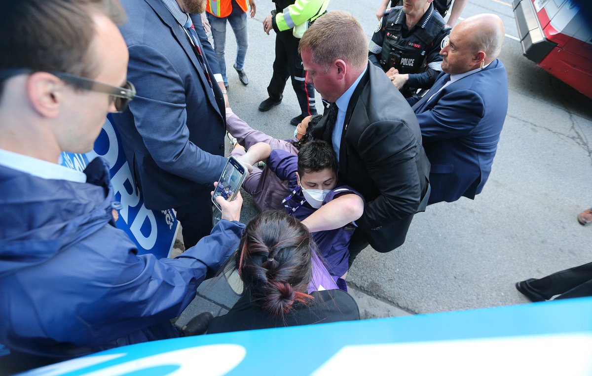 SteveRussell's tweet photo. A member of SEIU, the union that represents nurses, lies injured on Yonge St. after he &amp; others tried to sit in the path that Doug Ford would have taken. Supporters &amp; protesters gathered outside TVO site of the Provincial election leaders debate. #ONpoli #OntarioVotes https://t.co/x3XXOHg8Xm
