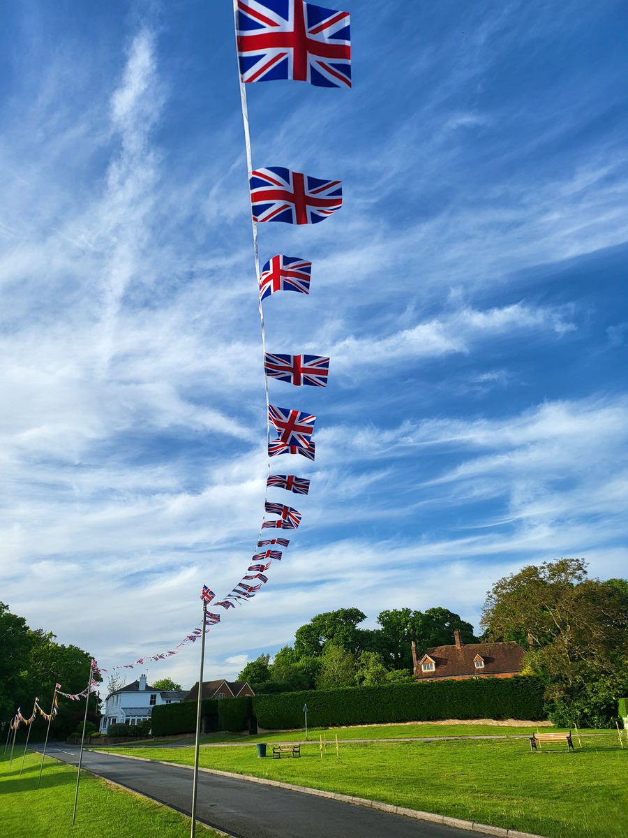 ChiddSummerFete's tweet photo. Bunting up on The Green and looking fabulous.  Cannot wait for 5th June Chiddingfold Jubilee Village Fete. https://t.co/6ai2jFhPeH