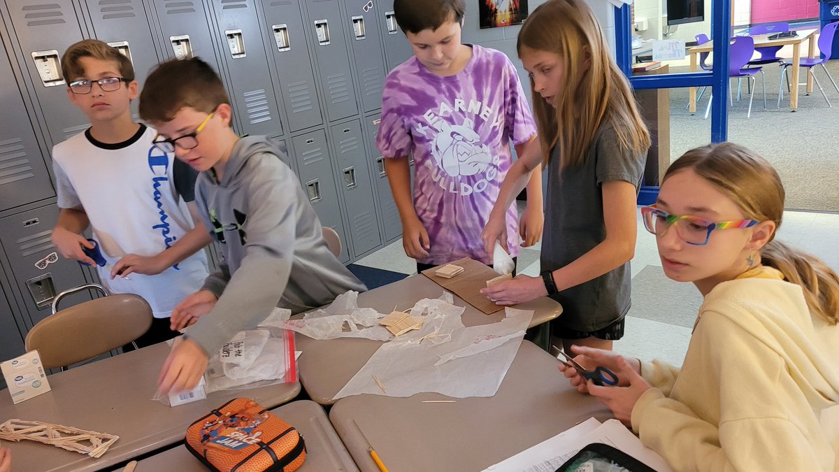 MrsThomasTeach5's tweet photo. This week's #PBL bridge challenge is to take their bridge and adjust their design to make it stronger. Many groups have gone back to the drawing board to redesign their bridge! 💜💛💜 https://t.co/HMWTgUTa6r