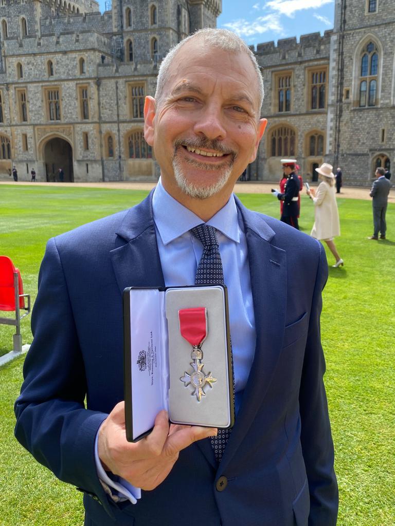 Karime Hassan receiving his MBE