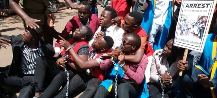 DoreenNyanjura's tweet photo. Unable to afford basic necessities for their education, today these university students armed with placards decided to peacefully demostrate what they're going through.

They were brutally arrested &amp; told to go back to their homes &amp; eat cassava if they can't afford education. https://t.co/D1MWeW3F6v