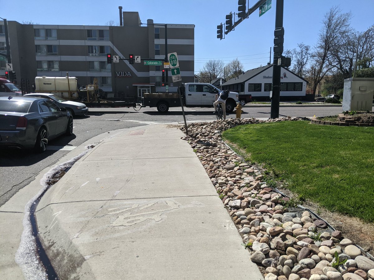 BryanByBike's tweet photo. Example of why I think I'll get killed by a car on #ColoradoBlvd.
Bike & Ped Infrastructure is designed to put us in the #KillBox.
The sand & rock show the trajectory that a driver took in a vehicle that surely would have killed anyone waiting on that corner.
#VisionZeroAction https://t.co/qdEtIqgdMB