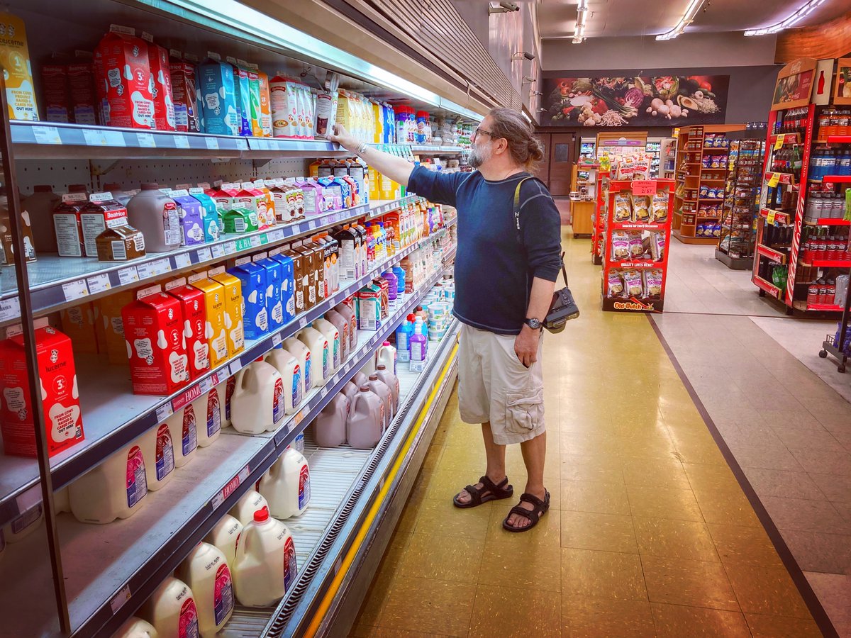 Yesterday afternoon I had such a great time on a walk in my neighborhood with fellow photographer, <a href="/GWebberphoto/">George Webber</a> 
We went to this Mayland gem, Family Foods, and he took this shot of me picking up some half &amp; half for making White Russians. 😉
#TheBigLebowski
