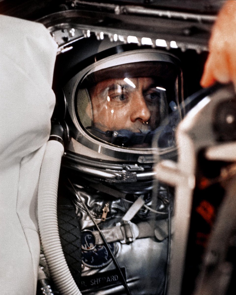 A close-up of astronaut Alan B. Shepard Jr. in his space suit with his helmet on inside the Mercury capsule. He is undergoing a flight simulation test with the capsule mated to the Redstone booster. This will be the first attempt to put a man into space by the U.S. aboard a Mercury spacecraft, launched atop a Redstone rocket.