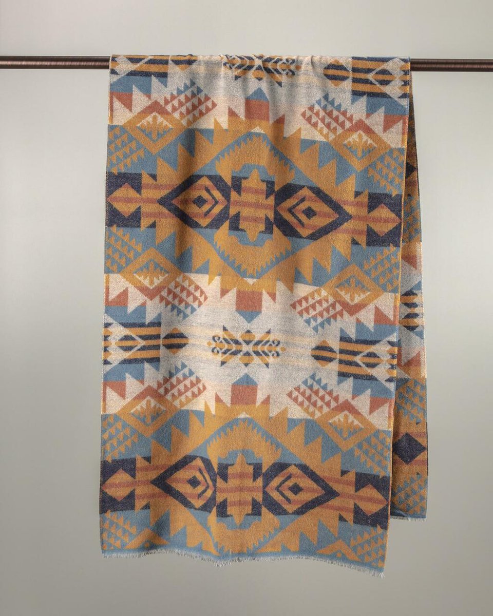 Image of a blanket with geometric shapes hanging.