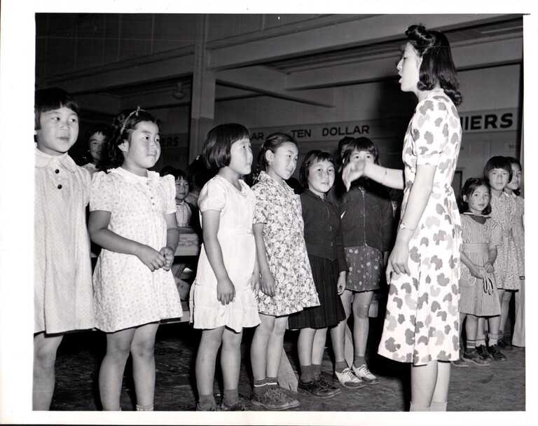 May 5 is #NationalTeachersDay . Meet Susan Mukai, one of the detainees who took it upon herself to teach classes at the Santa Anita Japanese Assembly Center. Here she leads children in singing the national anthem in the converted wagering room of Santa Anita Park.