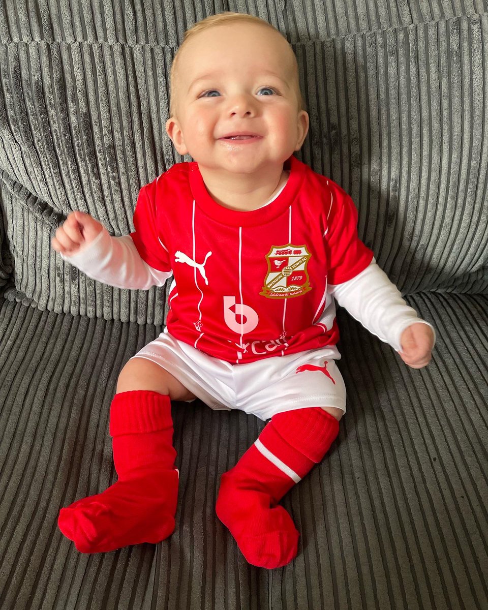 Finally got my boy his first <a href="/Official_STFC/">Swindon Town Football Club</a> kit. As you can see he’s chuffed to bits and with the weekend ahead and the play offs in our hands you can’t blame him. Welcome to the rollercoaster that is Swindon Town F.C #STFC #COYR