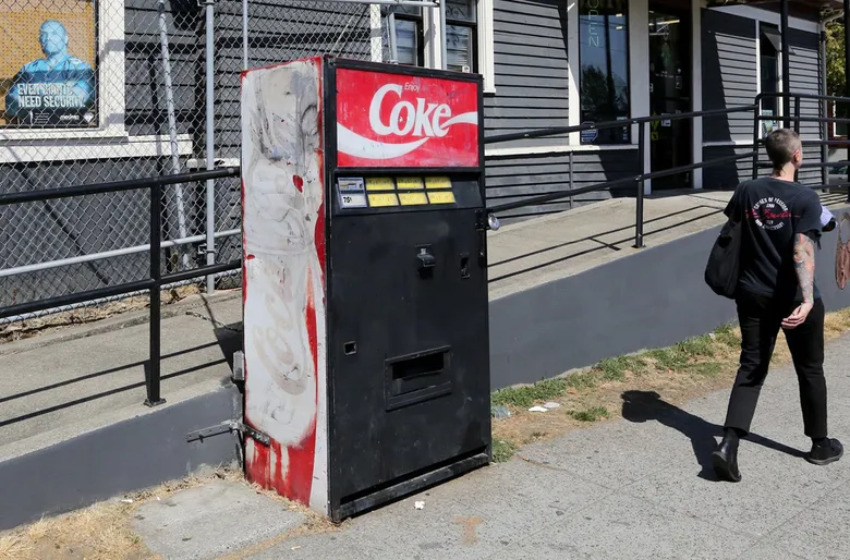 KirbyCheatFurby's tweet photo. apparently there was once this mysterious coke machine stationed in capitol hill from the 1990's to 2018

the machine had a variety of different sodas, and nobody knows who operated it

in 2018, it vanished, and in its spot was some tape that simply reads "went for a walk" https://t.co/thEOtrmo6j