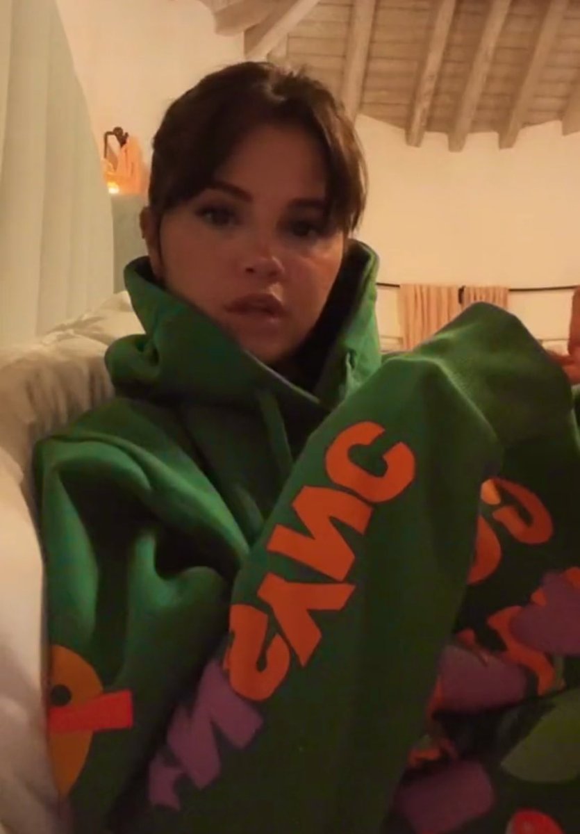 GomezSource's tweet photo. Selena Gomez wearing a “Guess What” NSYNC Hoodie in new Tiktok https://t.co/Wj0WXDwbGp