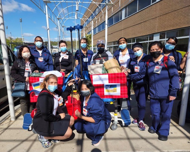 2FE UC members with boxes of donations in the Support of Humanitarian Efforts in Ukraine.