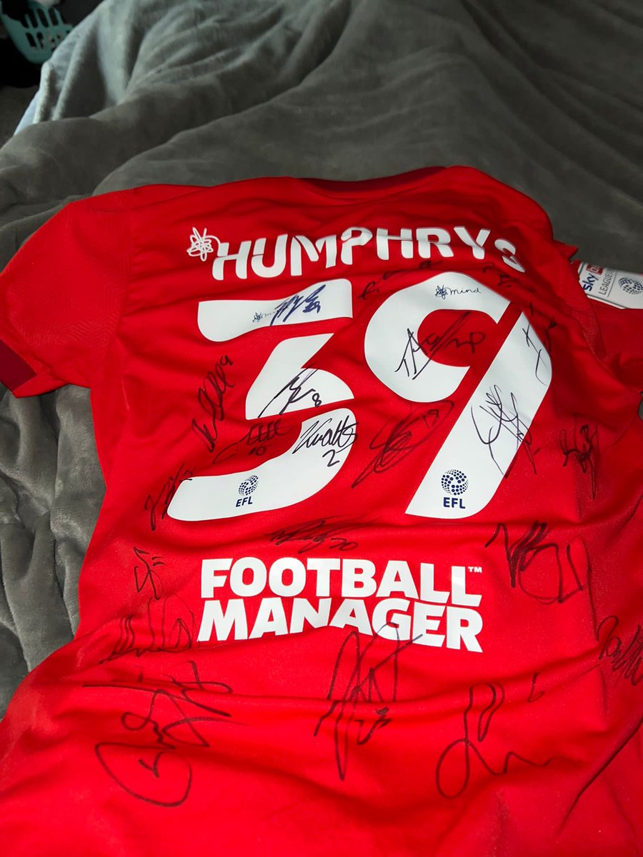 Smiggy's tweet photo. *SPOT THE BALL*

Wigan Athletic striker Stephen Humphrys has kindly donated me this match worn shirt signed by the League 1 winning team 🏆 to raffle off for my charity running challenge! 🏃‍♂️ 
 
£5 a team! ⚽️ 

DM me if you want a go! ✉️ 

#tics #wafc @HumphrysStevie 🐫 https://t.co/vF0qRkQiRz