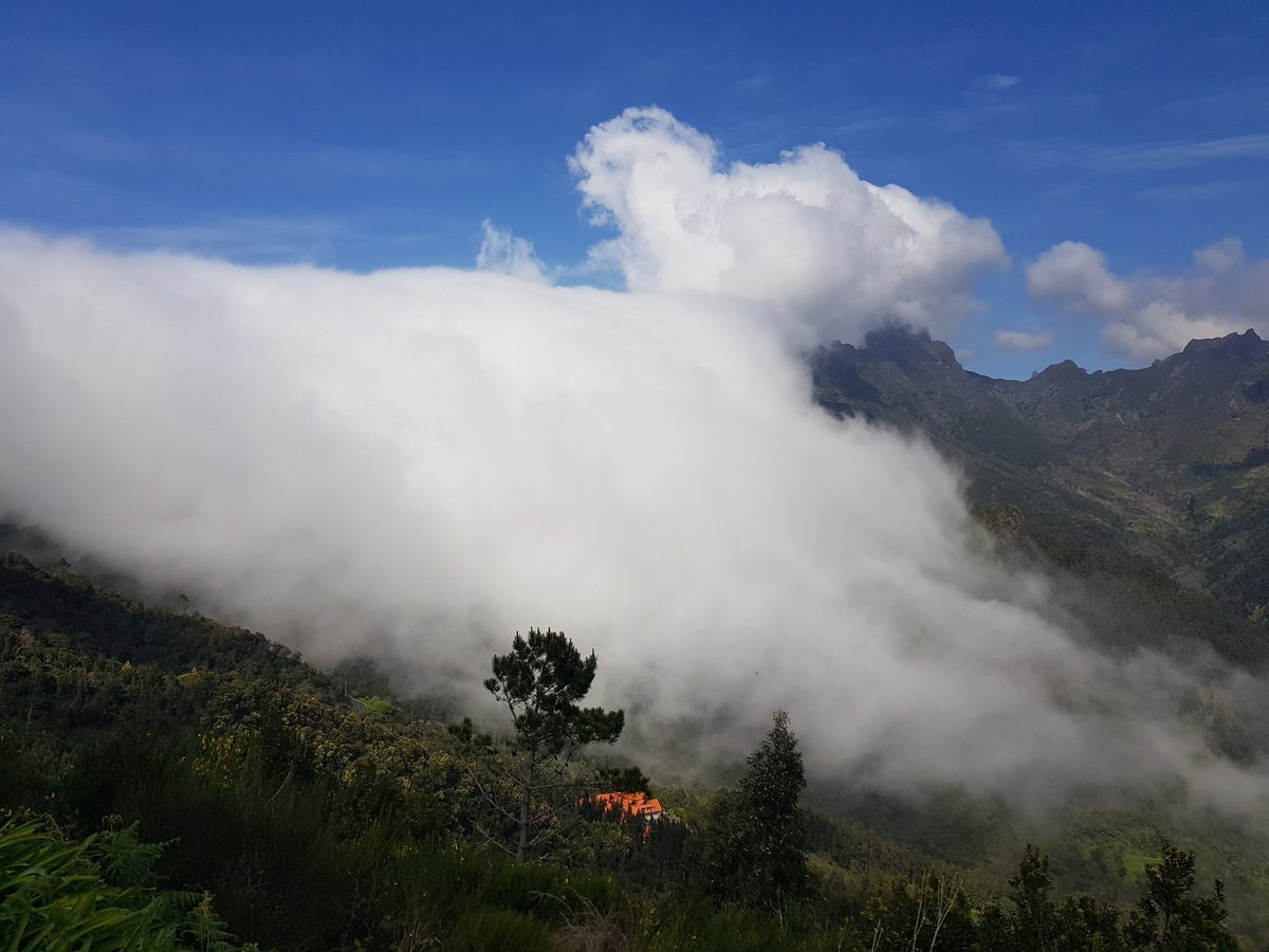 OurMadeira's tweet photo. A cloud flows over the mountain ridge, Encumeada, Madeira. #cloud, #madeira, #encumeada, #levadatrekking https://t.co/vniy9yZIl7