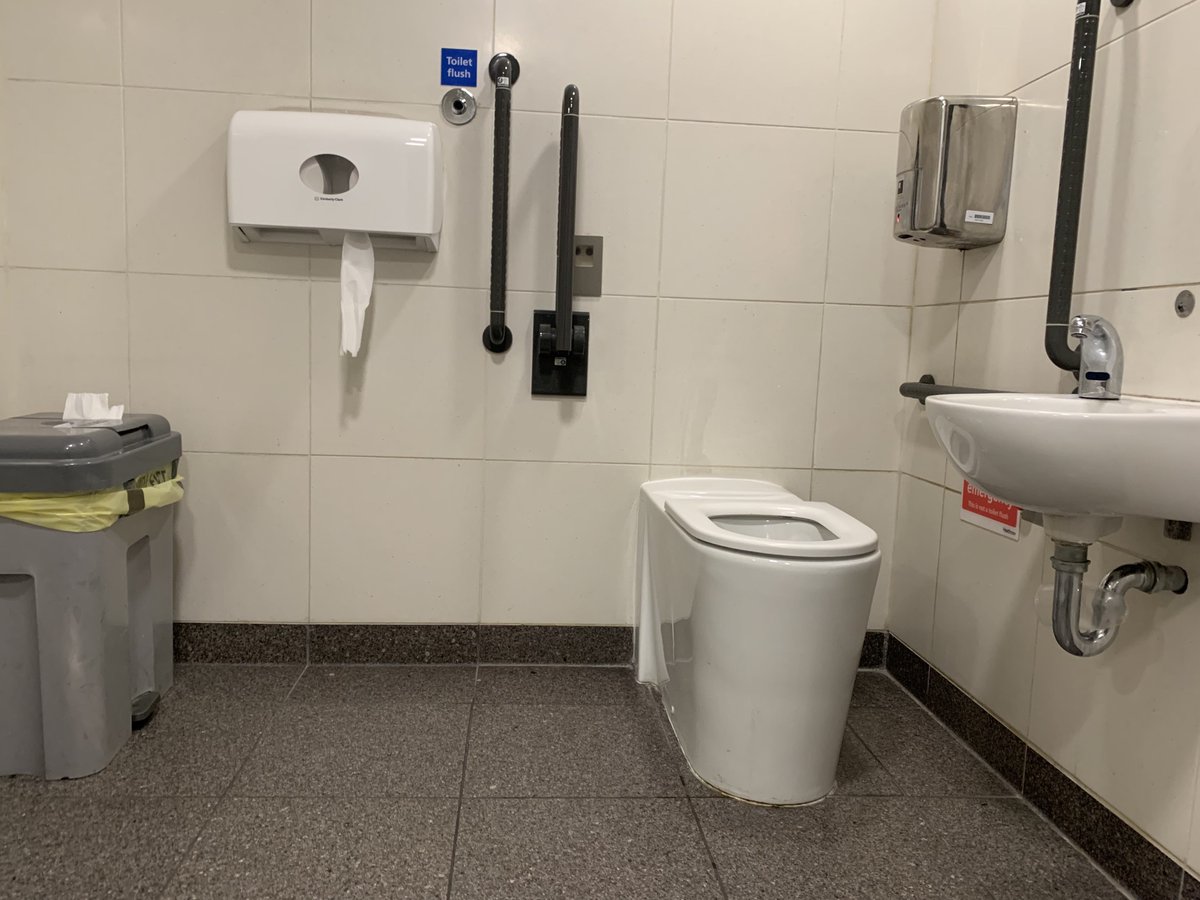 SandiAltner's tweet photo. This "accessible toilet" at Heathrow made me laugh once I figured out how to manage it. Note where the toilet paper is in relation to the toilet. And that flush button. Also, drying hands requires reaching over the toilet! Great design job! #travel #WritingPrompt https://t.co/jJVMawIRC7