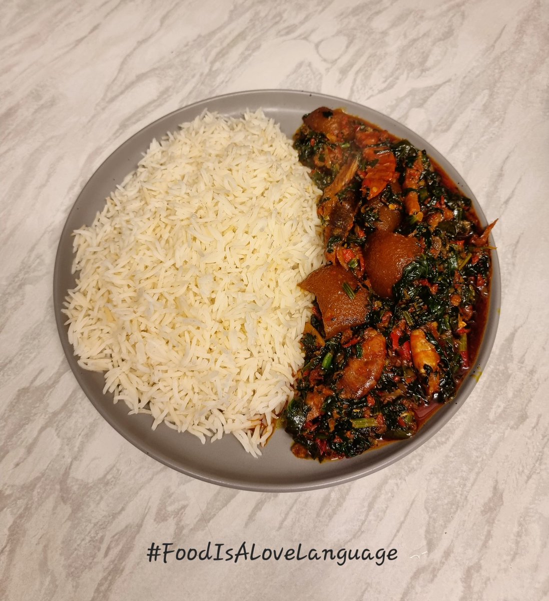 BukkyShonibare's tweet photo. White rice with efo riro - garnished with smoked prawns, smoked catfish, bonga fish, smoked turkey, and ponmo. 

#FoodIsALoveLanguage https://t.co/JtQCXhuTgq