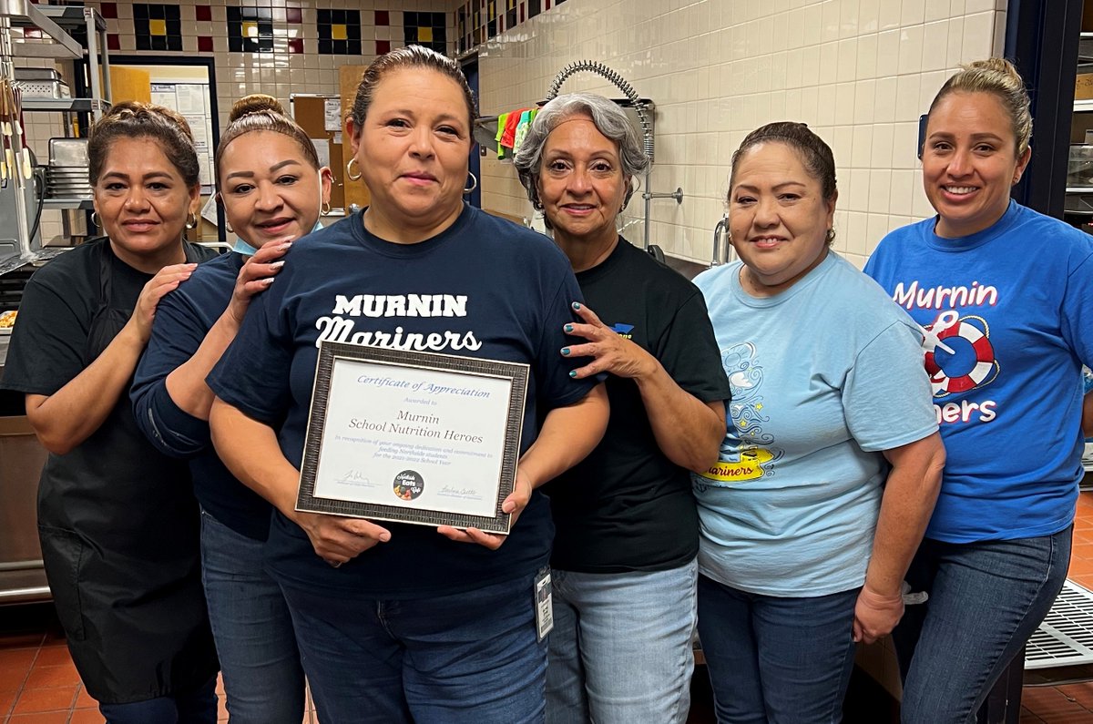 NISD's tweet photo. It's #SchoolLunchHeroDay! Here's the cafeteria staff from @NISDMurnin with a Certificate of Appreciation from their leaders. Approximately 1,000 dedicated Child Nutrition staff will serve approximately 16 million meals this school year! Thank you to these heroes! #NISDFamily https://t.co/8fk3F3BNTZ