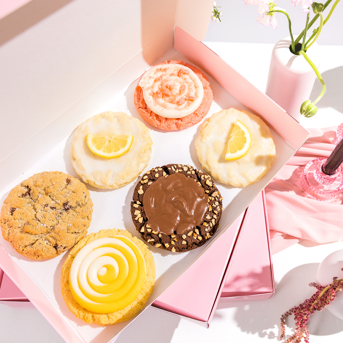 crumbl's tweet photo. We want to celebrate Mother's Day with you! 🖤 Tell us the best thing about your mother figure &amp; we'll pick FIVE people to send a 4-Pack Box to! https://t.co/MXCUh7nNri