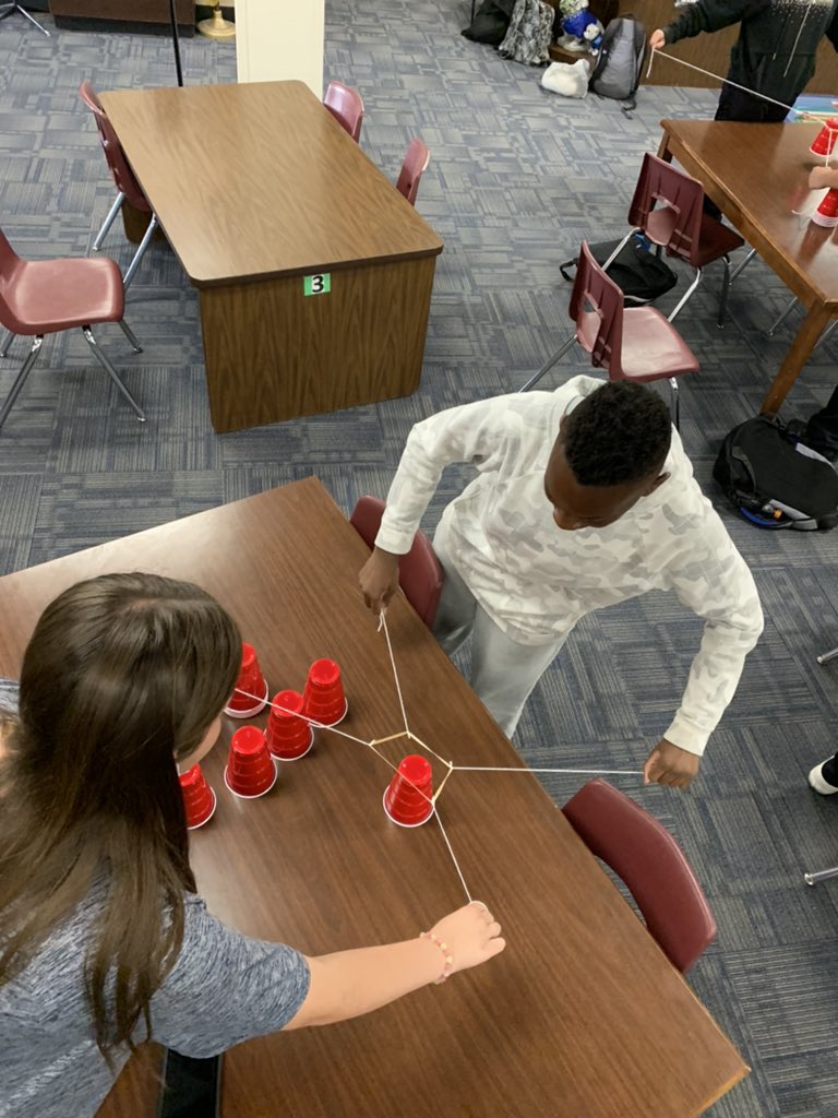 LGuerrero_MET's tweet photo. For Students Helping Students this week, we taught an activity where the kids had to stack cups using rubber bands and string! #PeoriaMET #PeoriaMETENG https://t.co/iu00Q5dSg3
