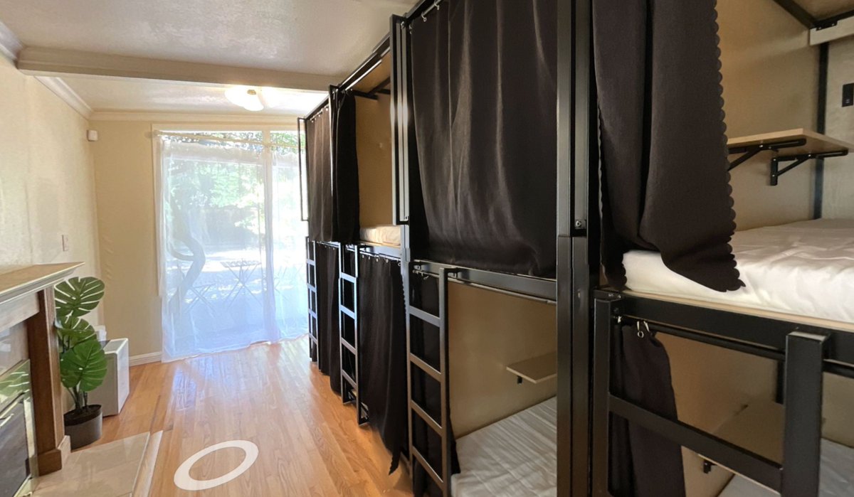rakyll's tweet photo. It's hard to explain how big of a deal housing in the Bay Area for those who are not from here. This "pod housing" initiative ($800/month) sleeps 14 people in a living room. Pods look like a jail cell rather than housing. https://t.co/tbkWsLo1Sc https://t.co/pOCTErjSvI