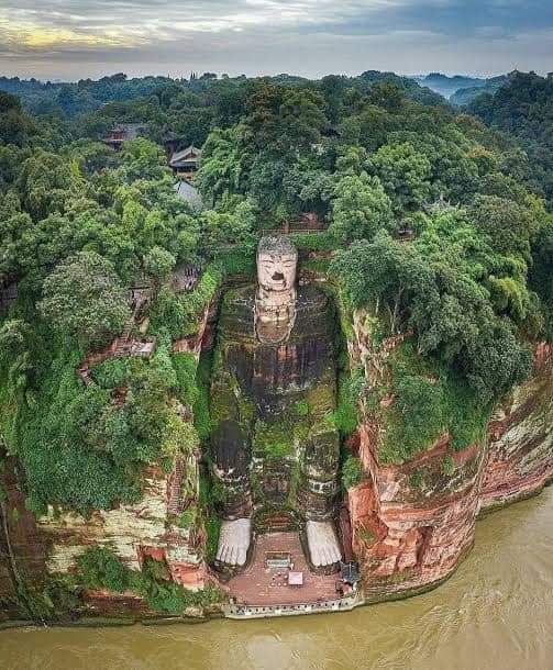 The 1300 years old Leshan Giant Buddha is a 71m tall stone statue, built between 713-803 (during Tang dynasty). Carved out of a cliff face of Cretaceous red bed sandstones that lies at confluence of Min River and Dadu River in southern part of Sichuan province near Leshan, China.