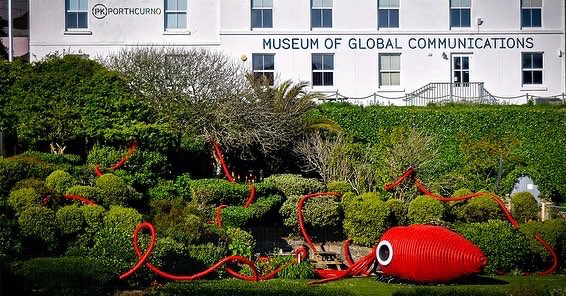 PlanetPK_'s tweet photo. Scientists have recorded certain species of squid using bioluminescence to communicate, flashing different colours and patterns on their skin to talk to each other and to warn off competition!

Morgy the Giant Squid of Communication has arrived at @pkporthcurno!

#PlanetPK https://t.co/vxYFCZI3sU