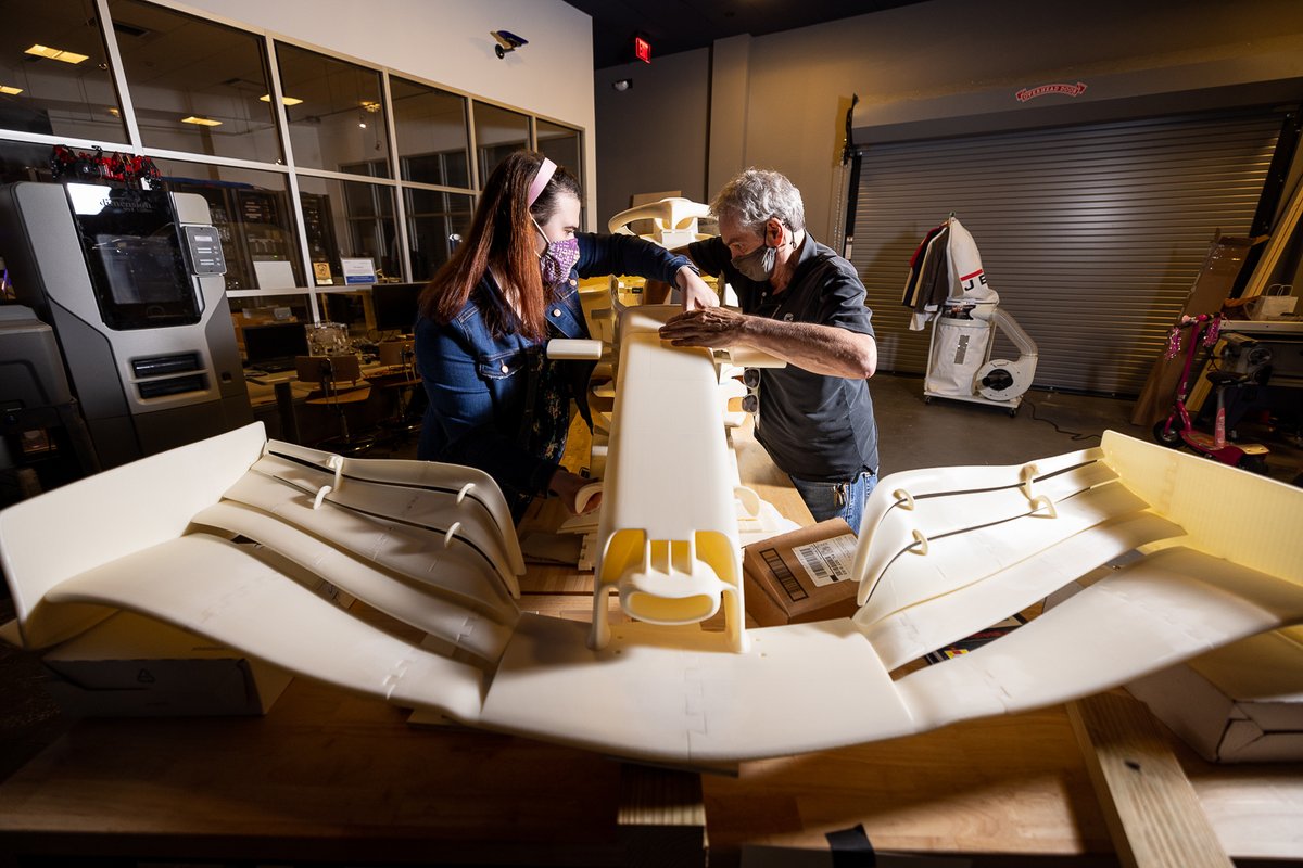 FullSail's tweet photo. Pat Starice and the Sim Viz program's newest alumna, Quinn, took a break from the life-sized #F1 3D Printed #RaceCar project and headed south, invited by @redbullracing, to the @f1miami for today's big race. #MiamiGP #FullSail #SimViz #RedBull #3DPrint https://t.co/LeJBeLQCB3
