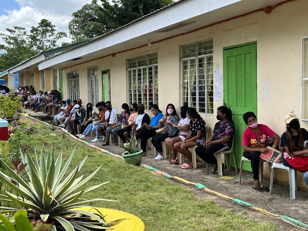 rapplerdotcom's tweet photo. @maracepeda Robredo has been waiting for about an hour and a half now here at Carangcang Elementary School. She’s mostly checking on her phone while in queue. She also has a bottle of drinking water with her. Heat is quite intense here. | via @maracepeda https://t.co/iJ25xr7ZQi