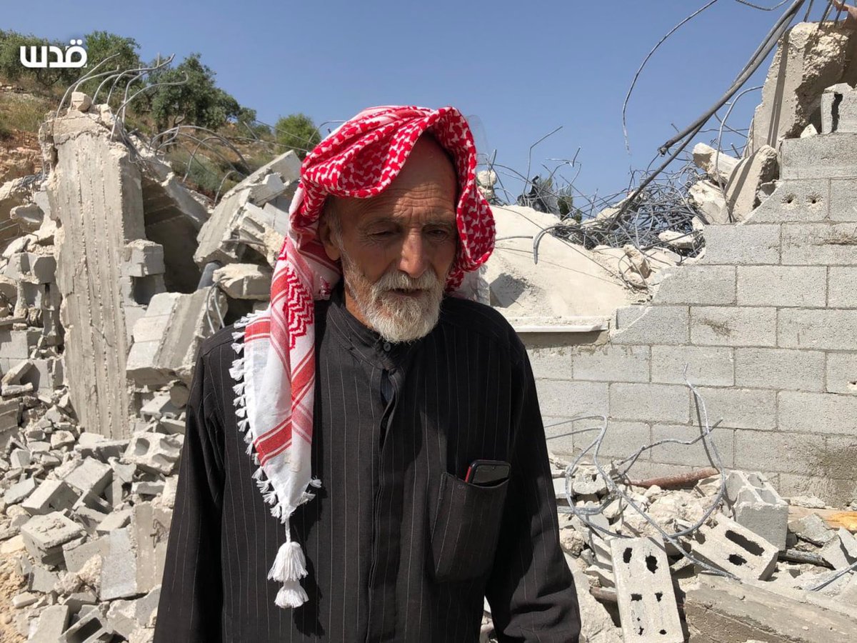 Timesofgaza's tweet image. A Palestinian elderly man whose house was demolished this morning by occupation forces stands in the rubble as  a witness to the Israeli crimes in Palestine.