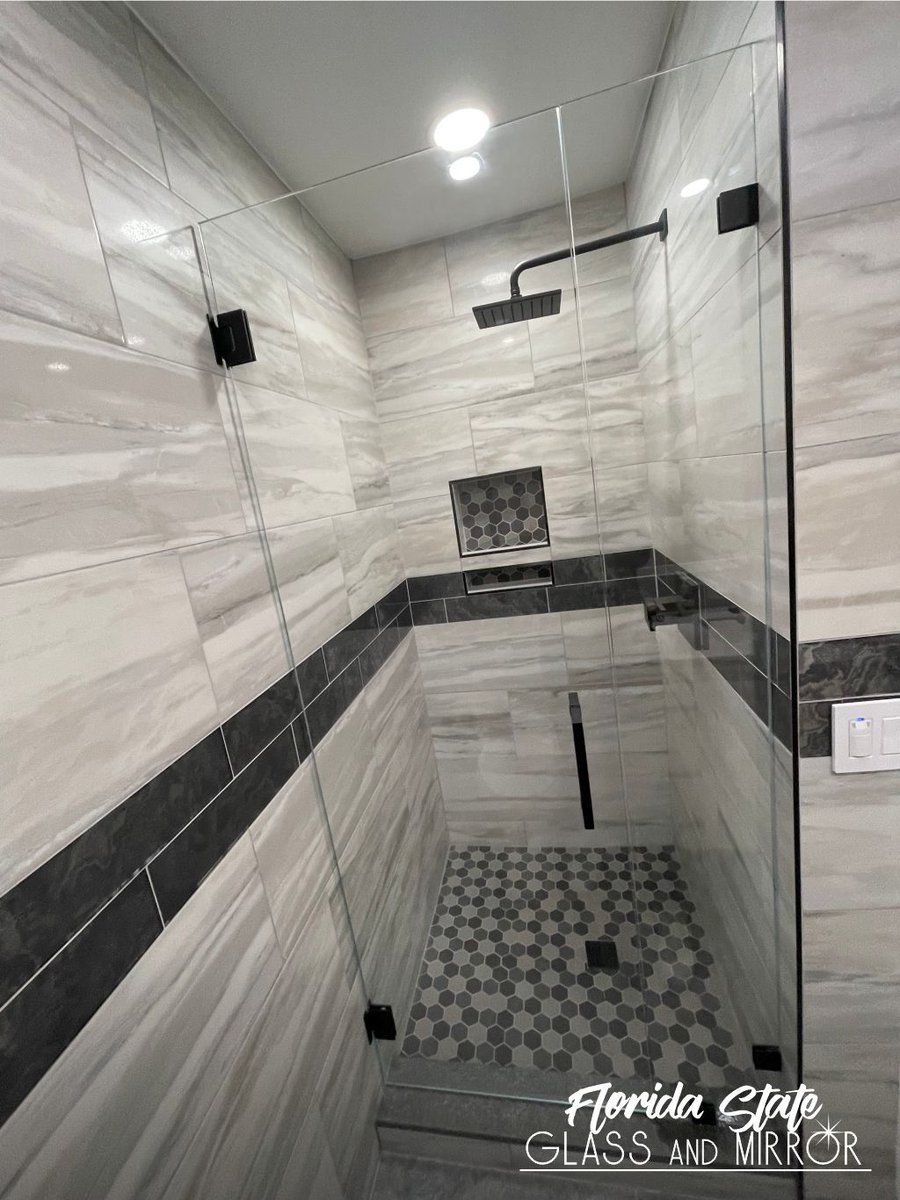 This Frameless Shower provides the ultimate in contemporary design for your bathroom. Call us now at 561-997-6990 to schedule a free consultation #framelessshowerdoor #blackhardware #shower #showerdoors #showerenclosure #glassandmirrorexperts #glassexperts #floridastateglass