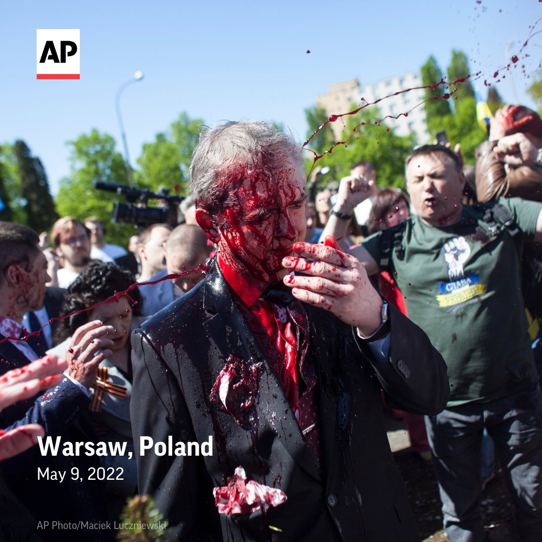 AP's tweet image. Protesters opposed to the war in Ukraine threw red paint on Russia’s ambassador to Poland Sergey Andreev as he arrived at a cemetery in Warsaw to pay respects to Red Army soldiers who died during World War II. apne.ws/uz9znRJ