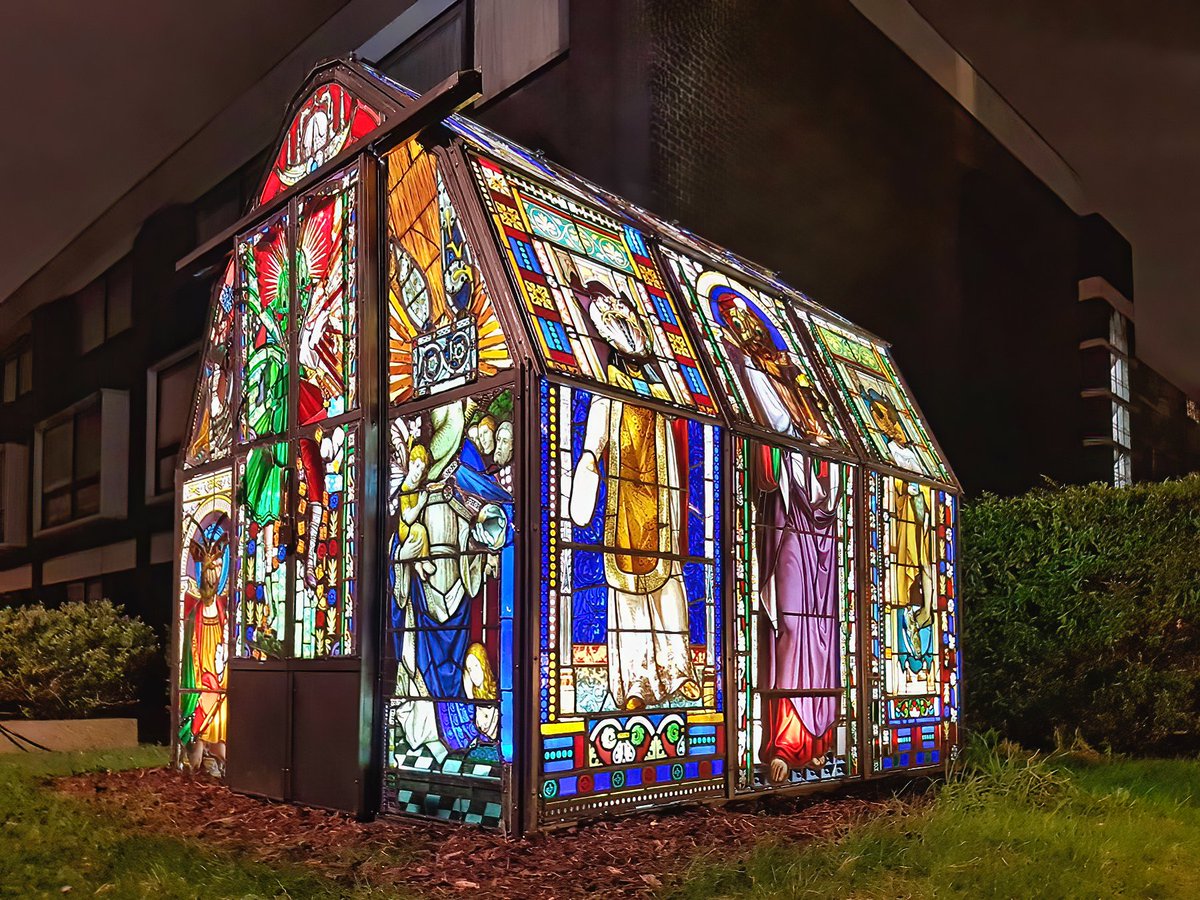 Green house, made from recycled church stained glass windows .