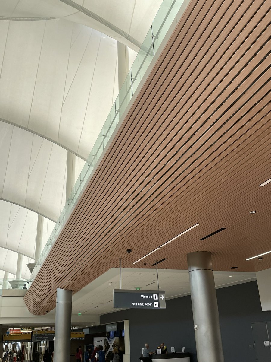 QPCFinishing's tweet photo. On todays episode of When Work Follows You- always exciting to step off of the tram at Denver International, hopping on the escalators up to baggage claim with all of my fellow travelers and looking up and seeing our beautiful wood grain powder coating above my head.  Smile. https://t.co/2hjrtmR7cu