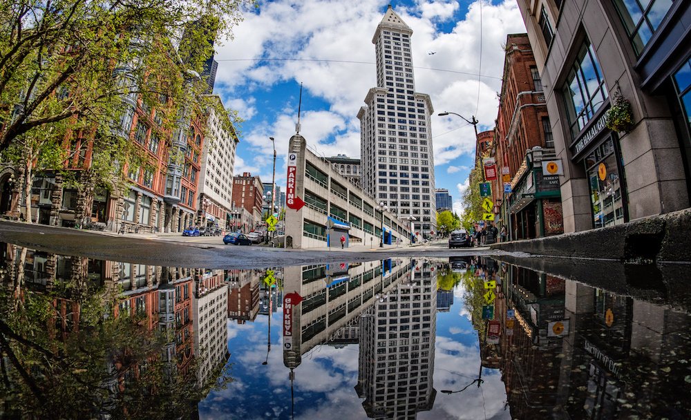 Do206's tweet photo. Say what you want about the weather this month, it’s giving us some great puddle content. This classic Smith Tower reflection puddle is #thriving. Got a puddle pic? Send it to us for a chance to be added to our guide and featured on socials. https://t.co/9TV5YWHYnJ #dostuffmore https://t.co/rdxb0f0TZA