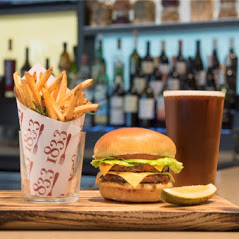 Celebrate National Hamburger Month by stopping into 1833 and indulging in our 1833 burger.  Two grilled beef patties | onion jam | bacon | american cheese | mustard aioli | pickle chips | brioche bun.  Pair it with a beer from our draft or bottle selection. Perfection at its best