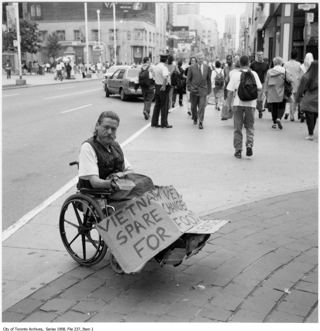 TorontoPast's tweet photo. Toronto in the 90's: Another capture by Ivaan Kotulsky. Yonge St ca 1995. Vietnam Vet asks for help just south of Dundas St on the east side.  What an eye. (Toronto Archives)..
.
.
#toronto #torontopast #torontoskyline #torontophoto #downtowntoronto #toronto90s #retrotoronto https://t.co/K6Mbco8K2M