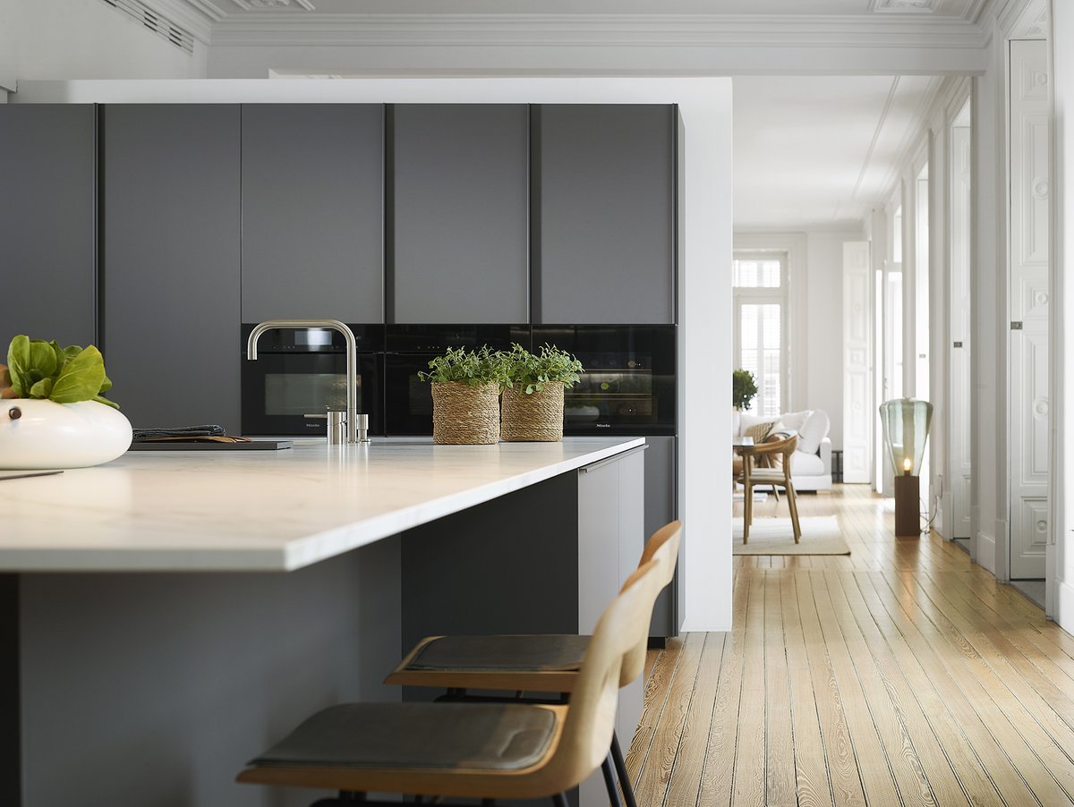 Una #cocina abierta amplia, sobria y elegante | El predominio del blanco en paredes, techos y ventanas potencia la luminosidad de la estancia, mientras que los muebles de líneas minimalistas, en color gris, aportan contraste y personalidad. ¿Te gusta?

#cocinasSantos