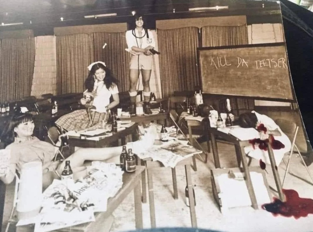 Here we have Irene, Imee and presumptive Philippine president Bongbong Marcos “gunning down” an unknown person in some kind of dress-up skit. The words “KILL DA TEETSER” is written on a blackboard.

You can’t make this up.
