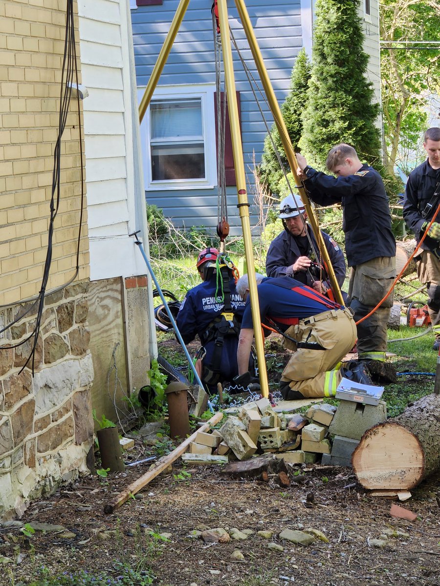 Lowering team member into hole.