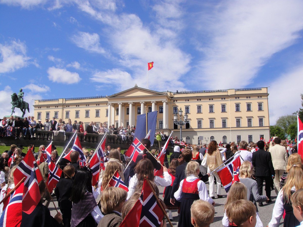 Children waving Norwegian flags in front of the Royal Palace.