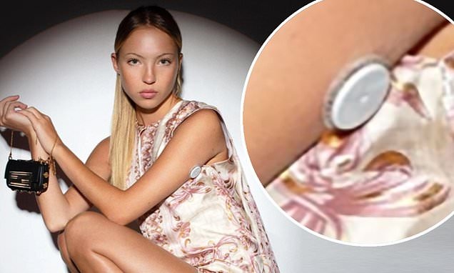 The 19-year-old daughter of catwalk icon Kate Moss, models a tiny handbag for the cult collaboration

+ The photo also sees Lila display her continuous blood glucose monitoring device on her upper-right arm, which she wears to control her Type 1 diabetes