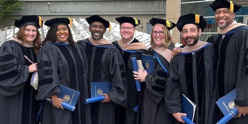 JWUOnline's tweet photo. Meet JWU’s first graduating class of the Doctor of Business Administration program. This first cohort started in 2018 and supported each other through the entire process. Congratulations to the new DBAs! https://t.co/3iZ6lVRpSr