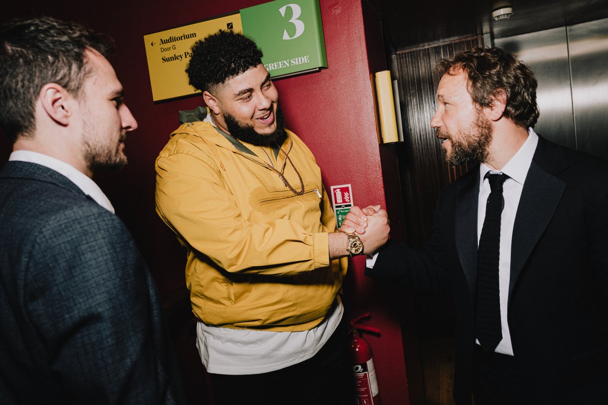 Big Zuu shakes hands with Stephen Graham backstage at the Virgin Media BAFTA TV awards
