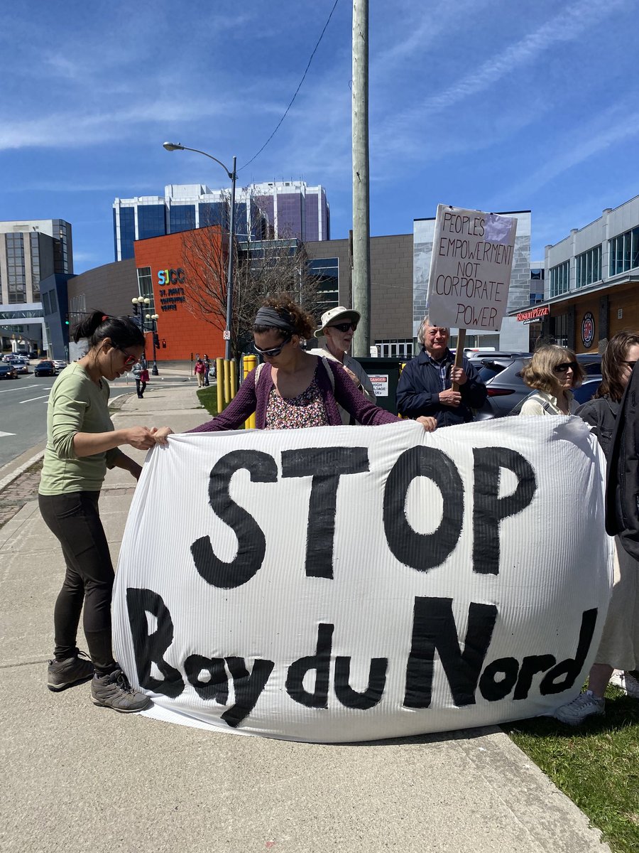 SJCNL709's tweet photo. Protestors hold a large banner that says STOP Bay Du Nord. It's a beautiful day in downtown #YYT to send a strong message to @Equinor to #StopBdN 📣 Oil and gas is in the past! https://t.co/XqPZcyrn2R