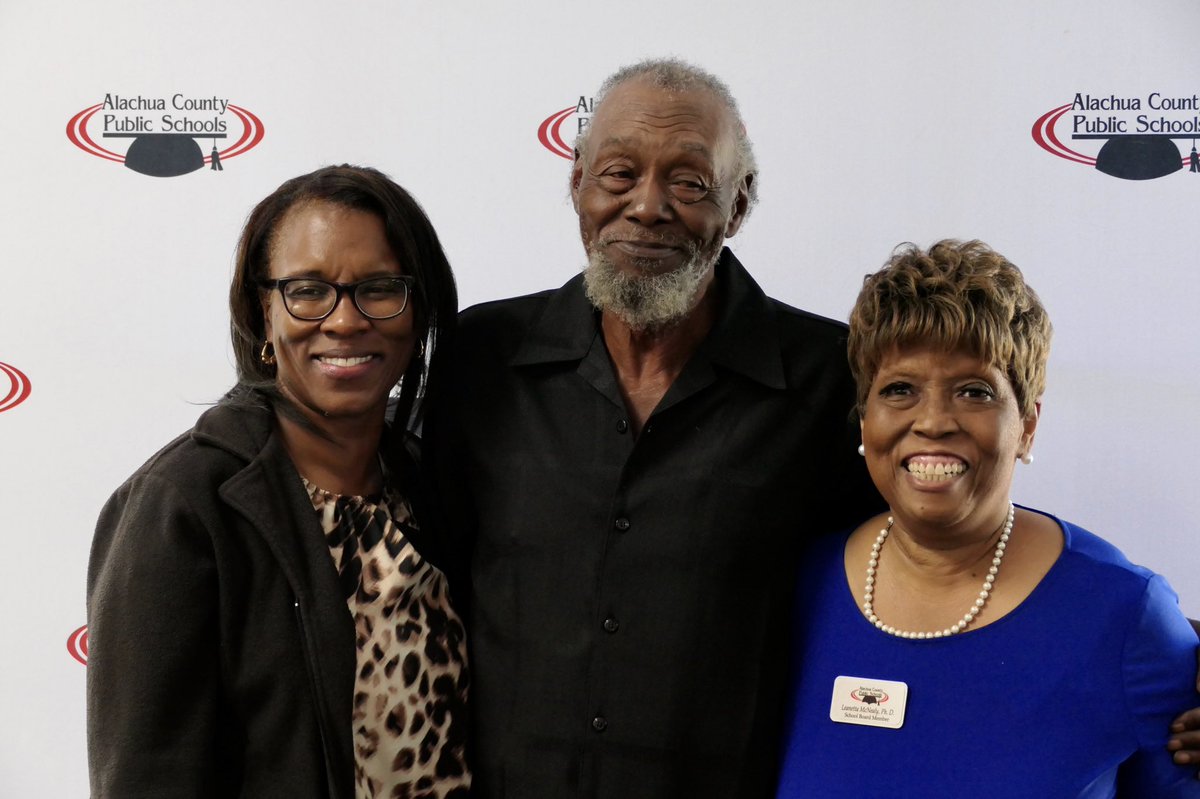 A man and two ladies posing for a photo