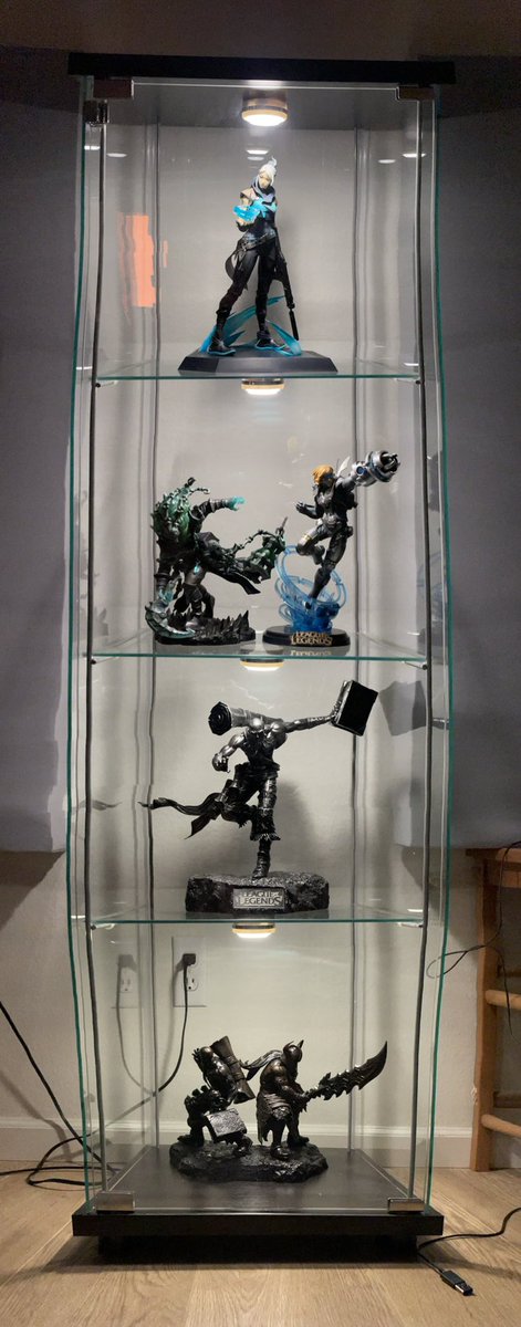 c3sound's tweet photo. Wonky pano of the display case I got for just a few of my Riot statues. #jett from #VALORANT and the third one down is a limited run #Ryze from a Riot Rumble win a loooooooong time ago. https://t.co/kHqPY5vRkQ